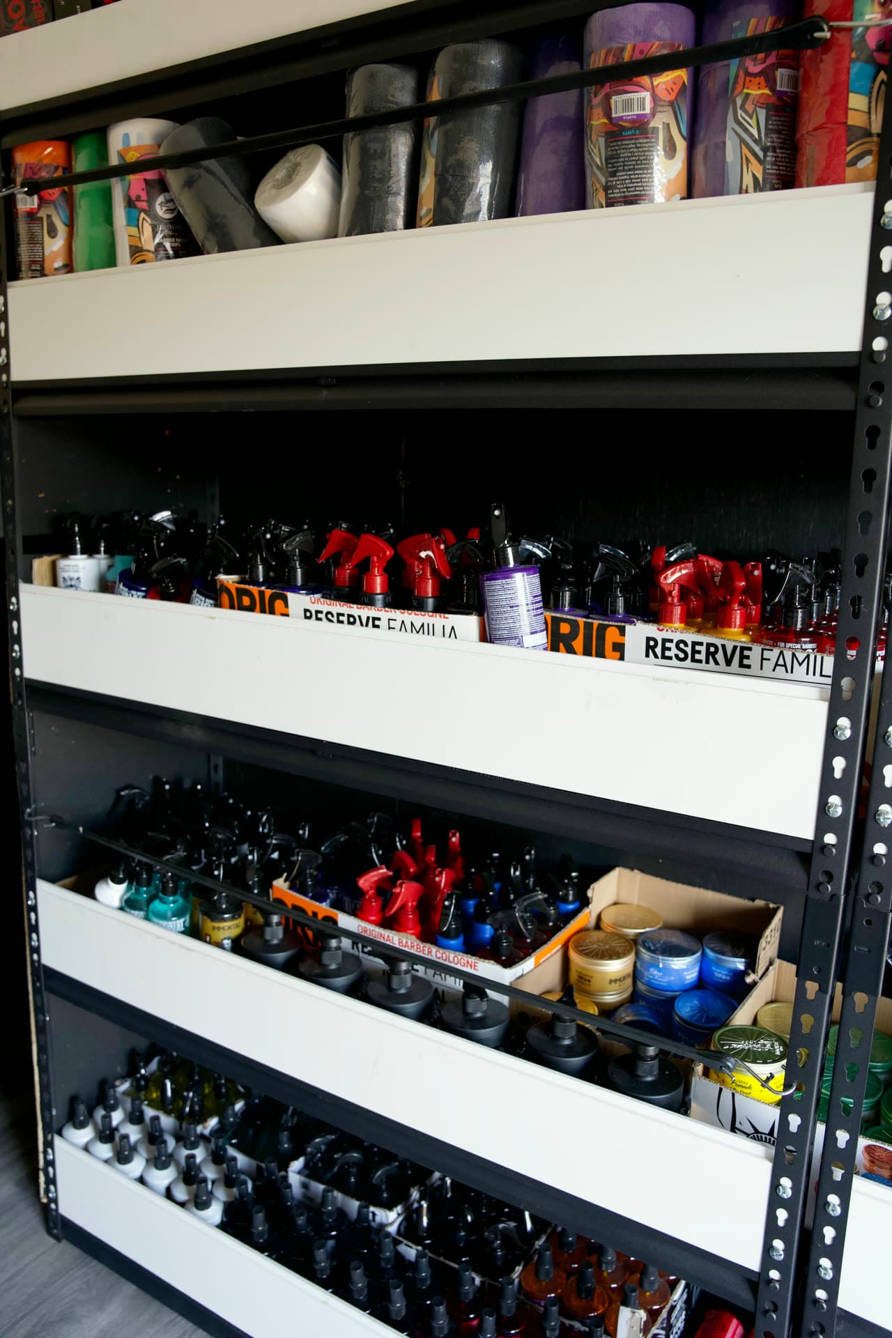 Stocked shelf wall inside the Tri-Cities Mobile Barber Supply trailer